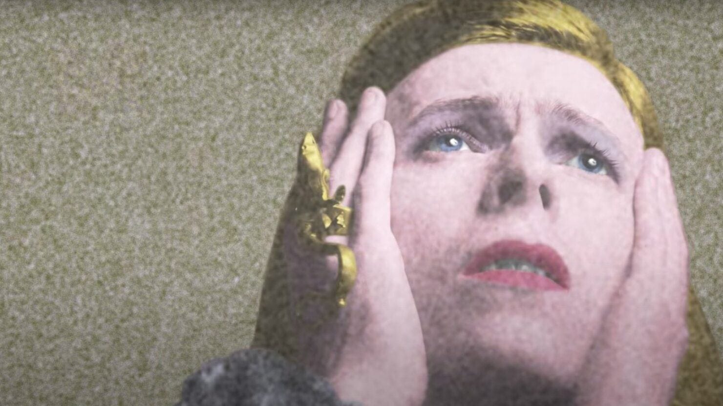 David Bowie from the photo shoot for the album, Changes, where he's holding his cheek and looking forlornly up to the sky.